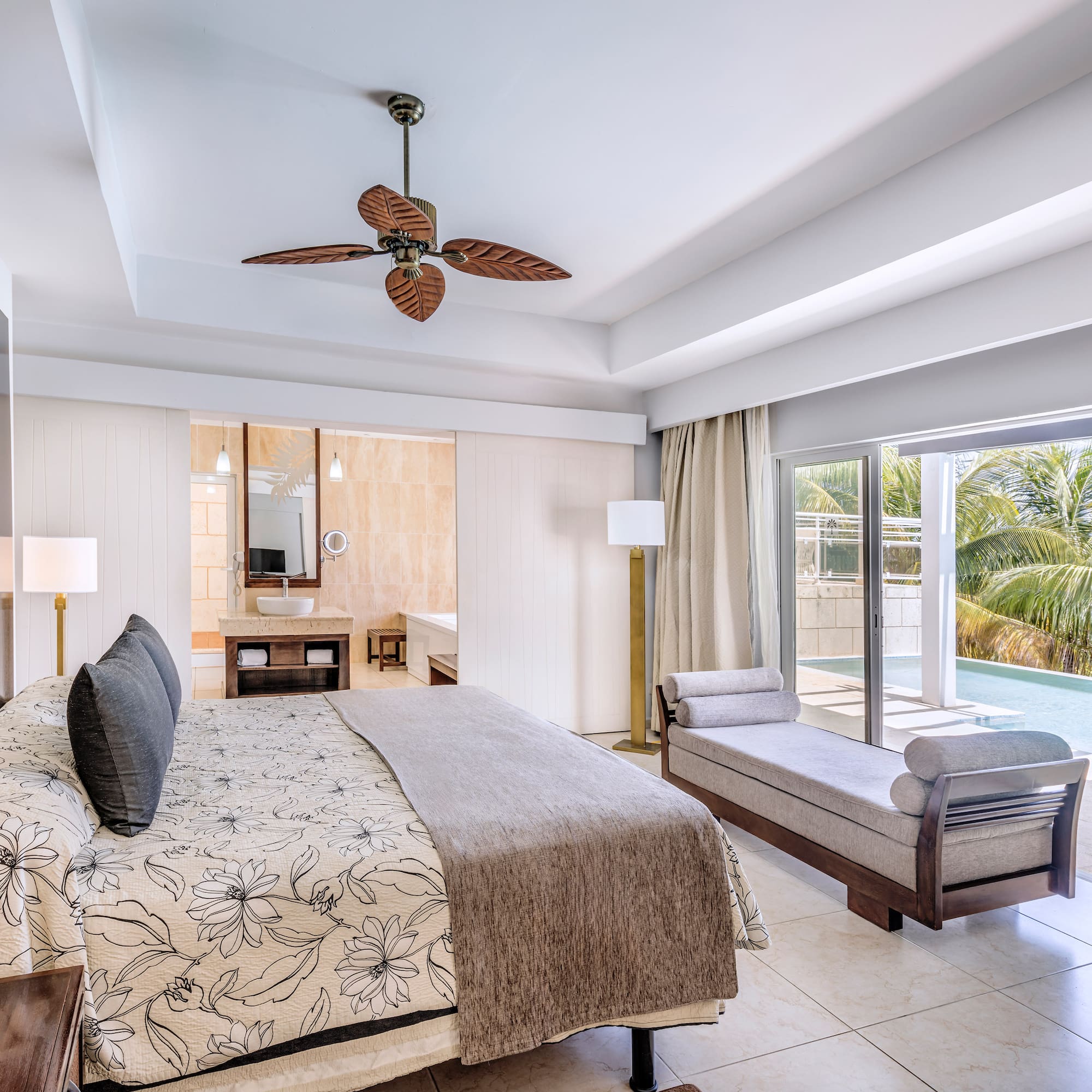 a bedroom with a bed and a pool in the background