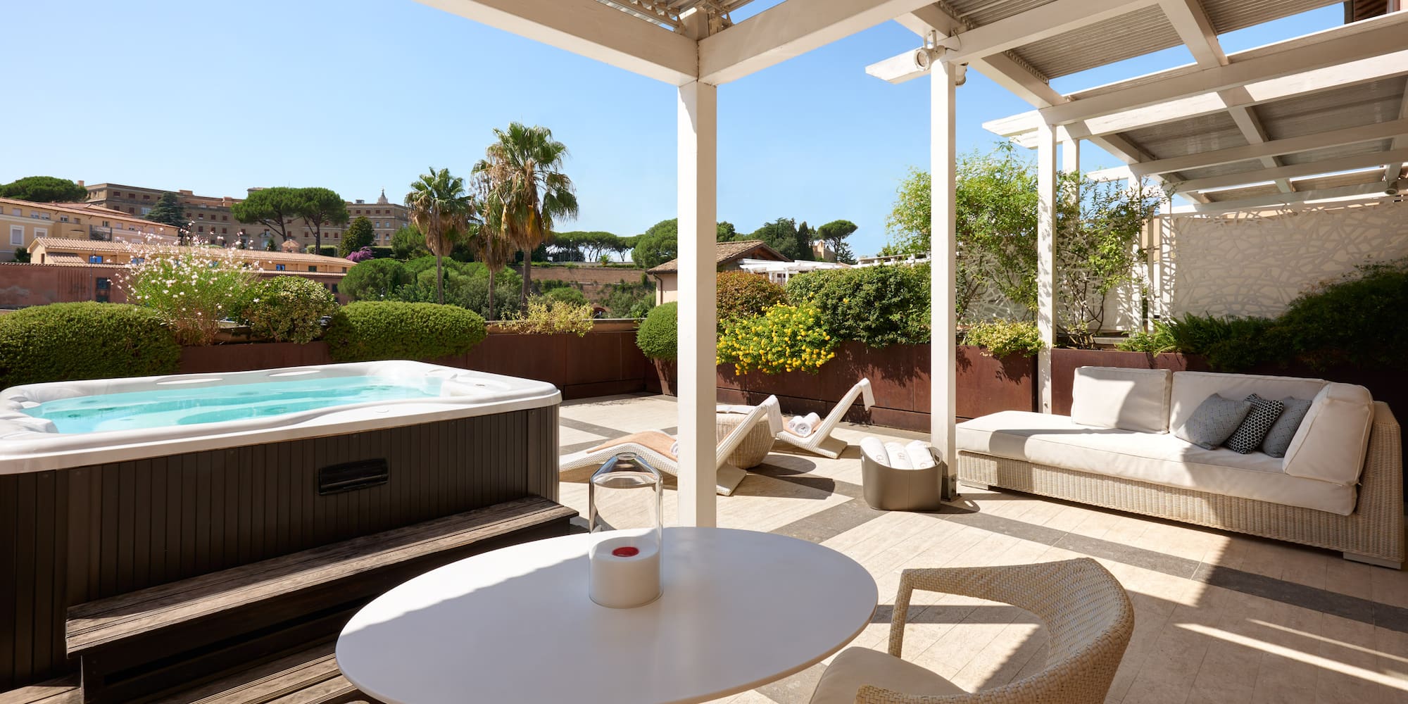 a patio with a hot tub and a table