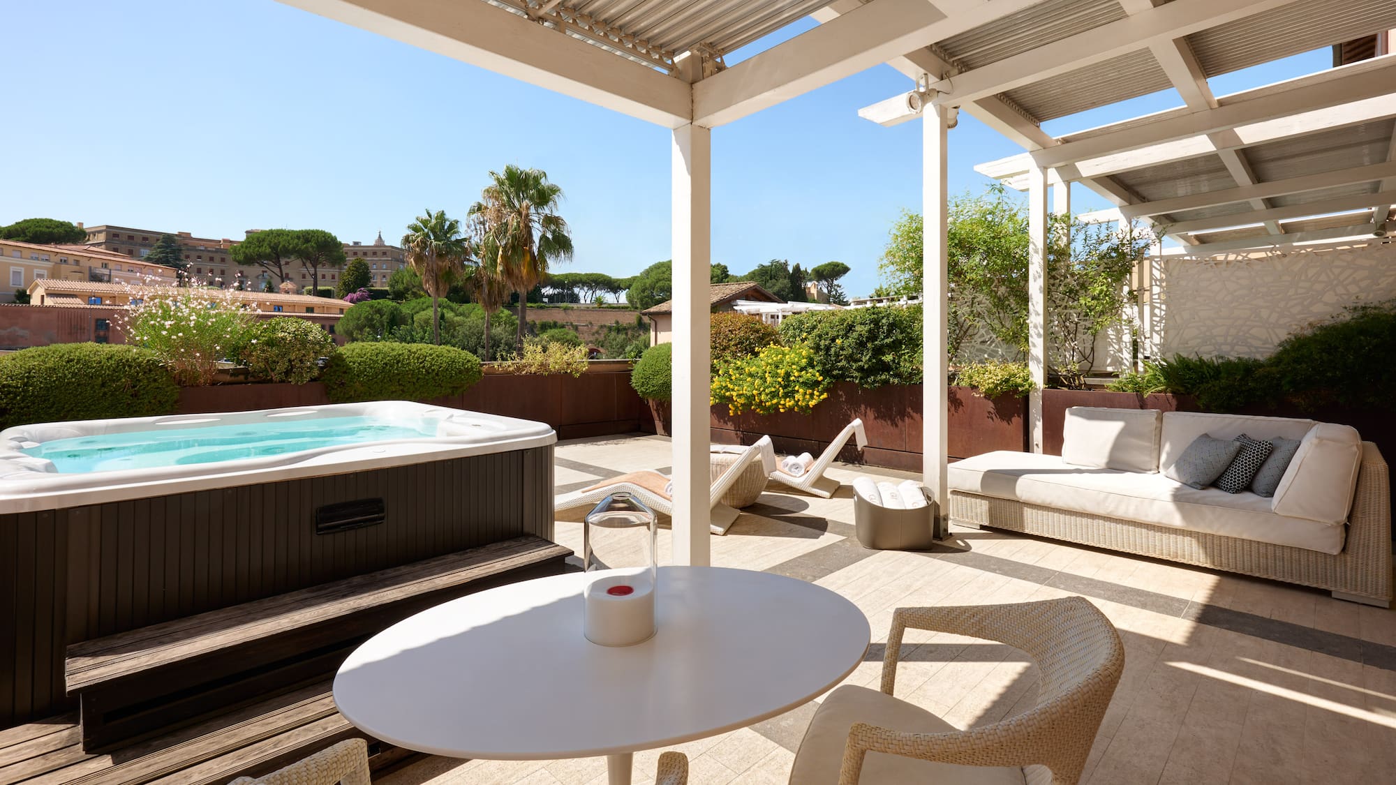 a patio with a hot tub and a table