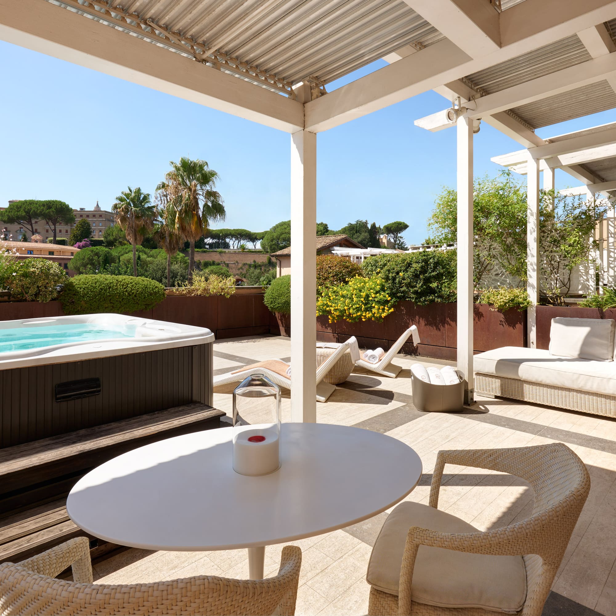 a patio with a hot tub and a table
