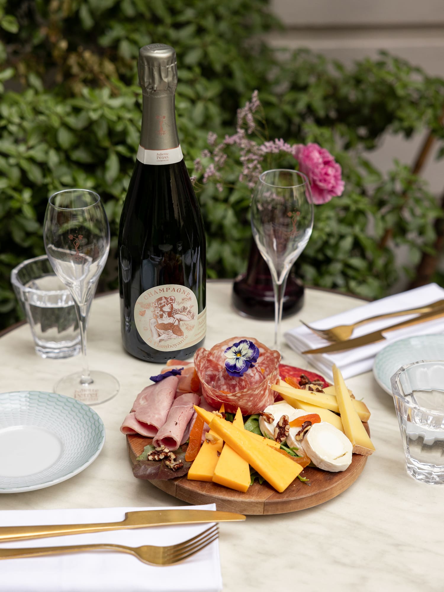 a plate of food and wine on a table