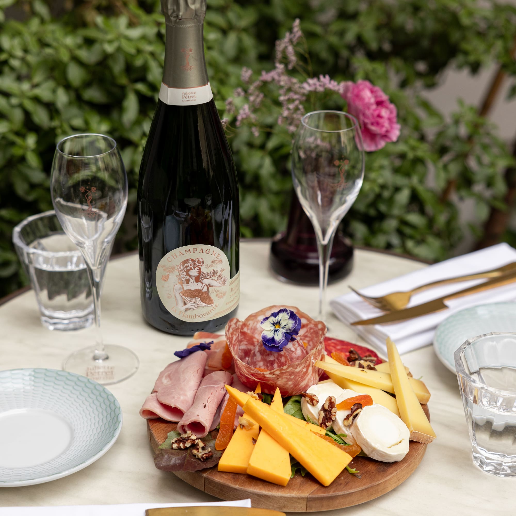 a plate of food and wine on a table