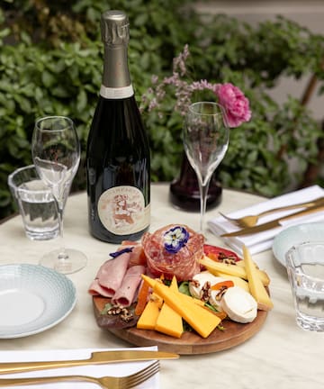 a plate of food and wine on a table