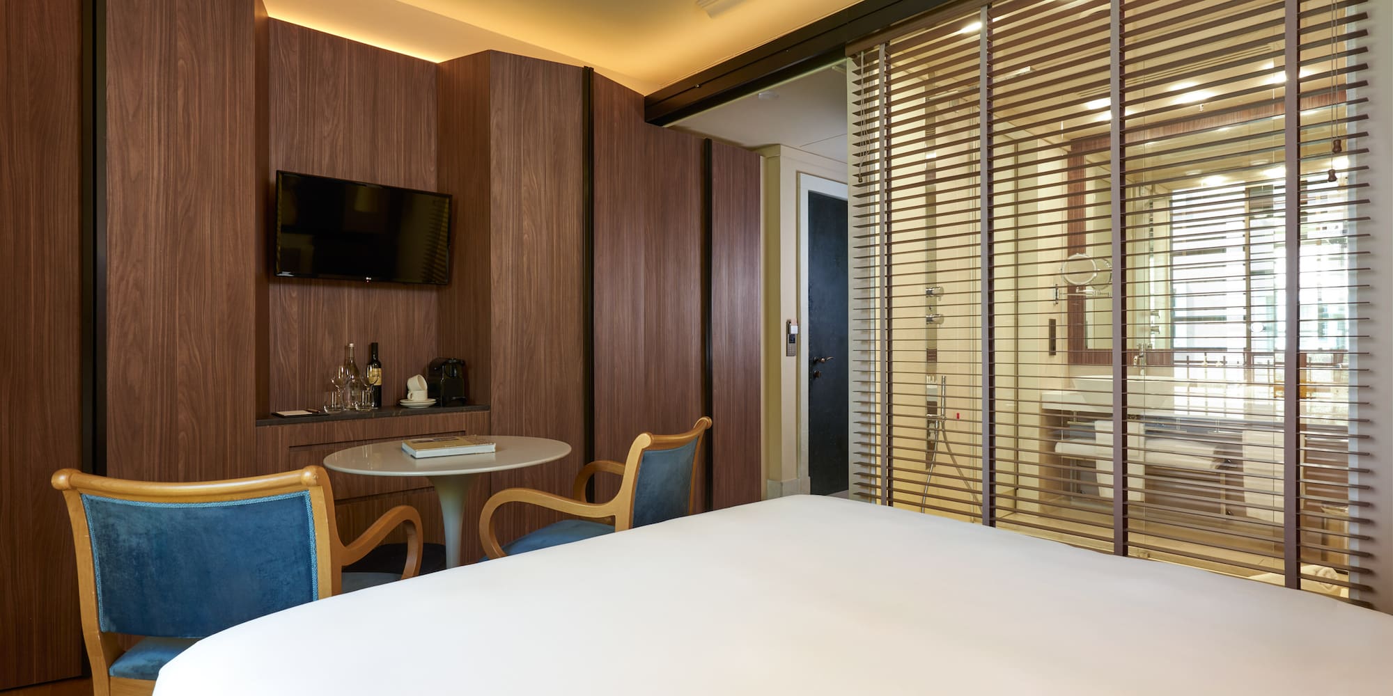 a room with a bed and a table and chairs