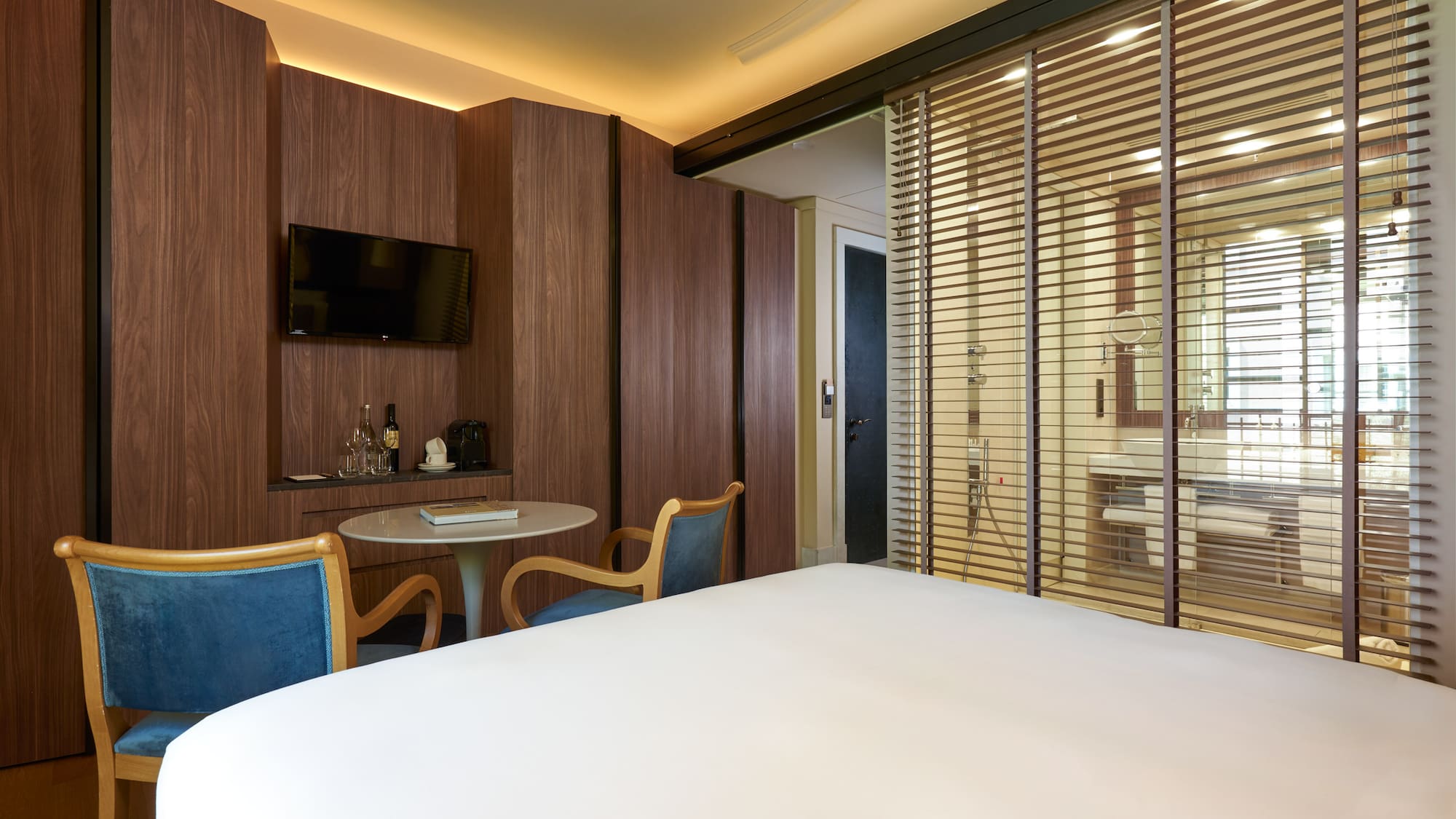 a room with a bed and a table and chairs