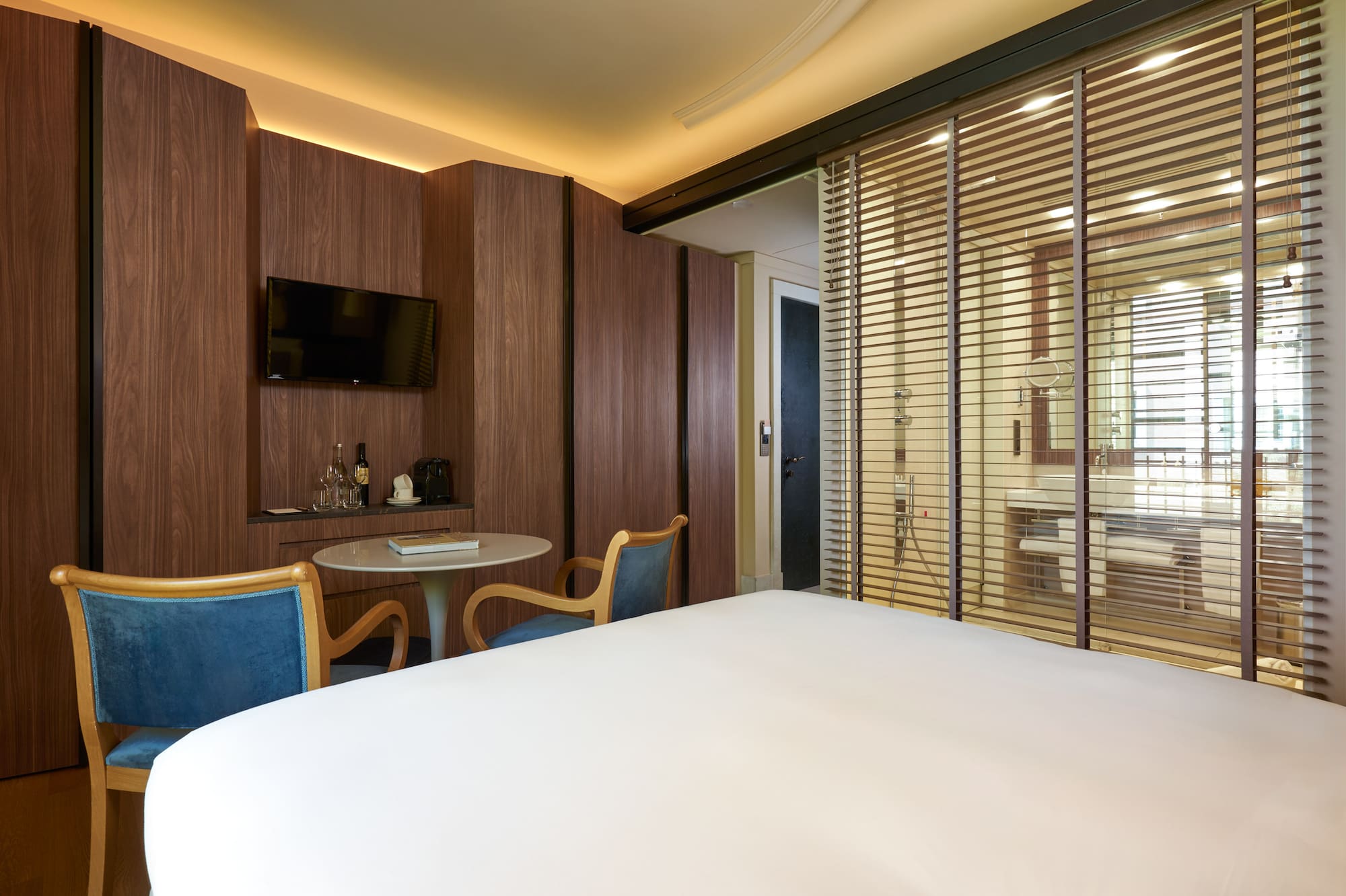 a room with a bed and a table and chairs