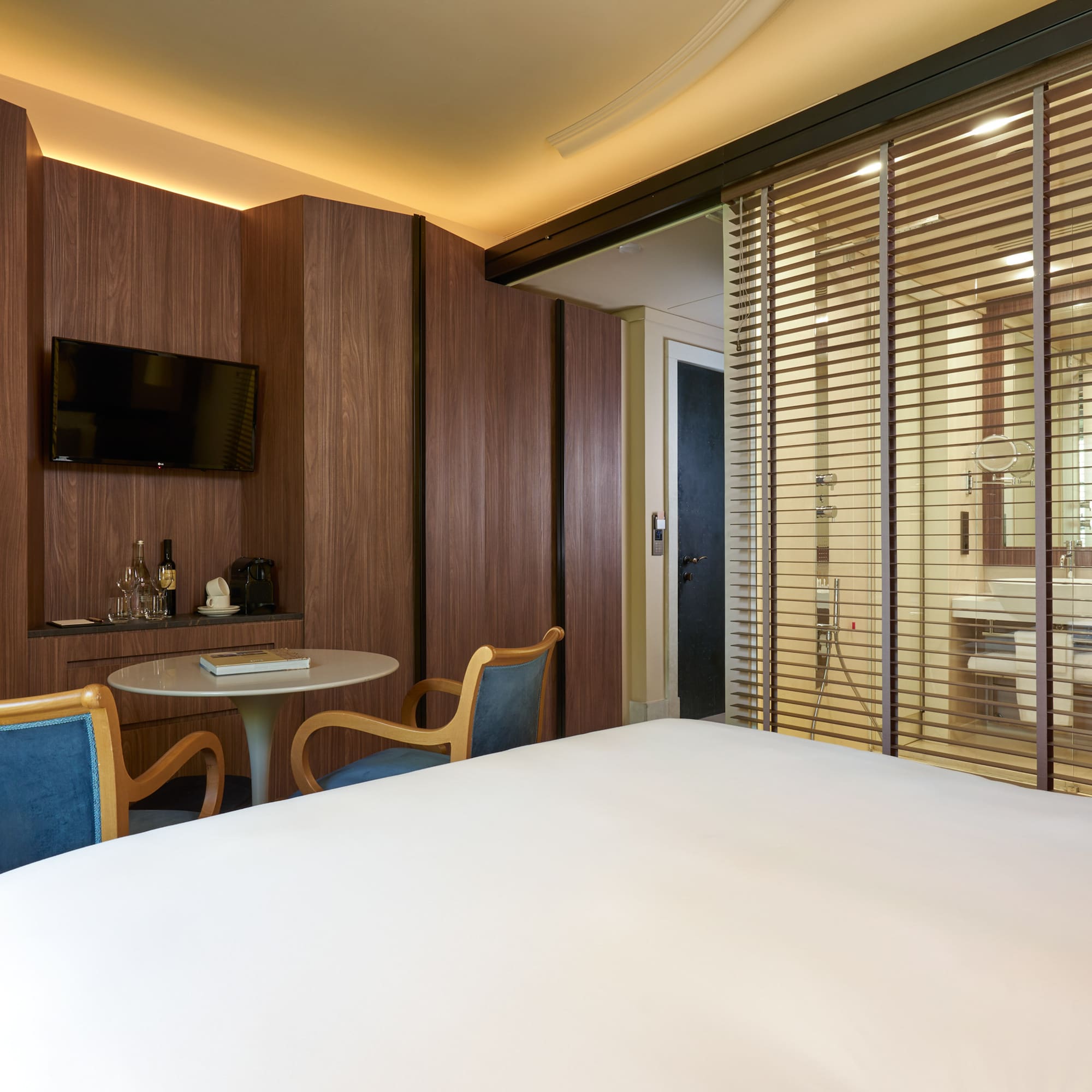 a room with a bed and a table and chairs