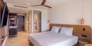 a bed with a wooden headboard and a ceiling fan