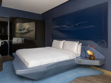 a bed with a blue headboard
