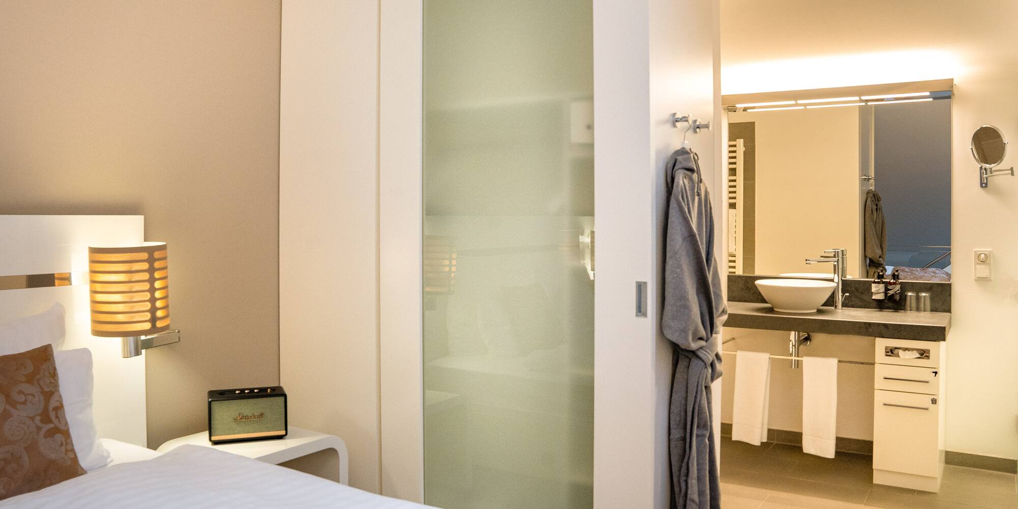 a bedroom with a door and a mirror