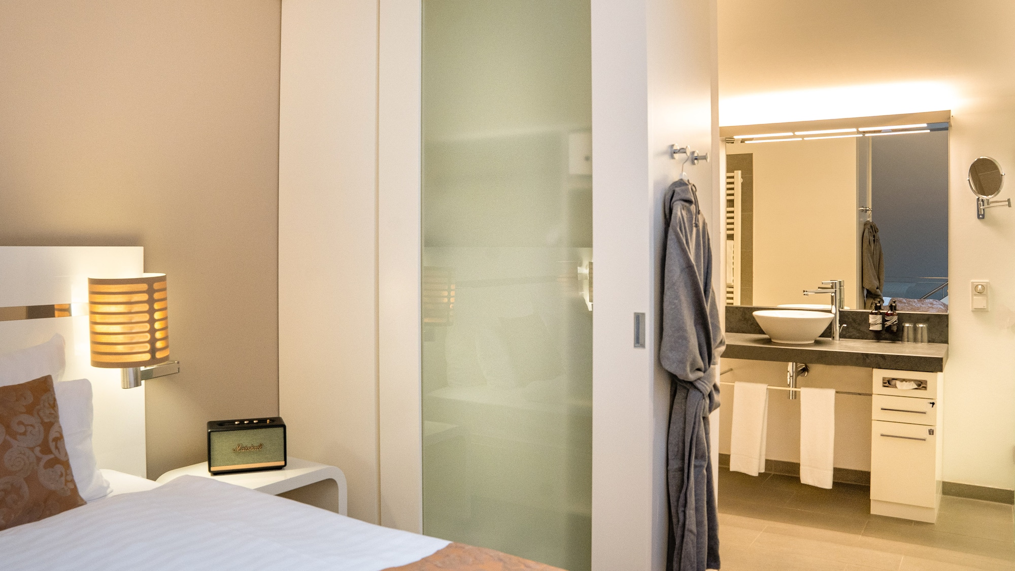 a bedroom with a door and a mirror