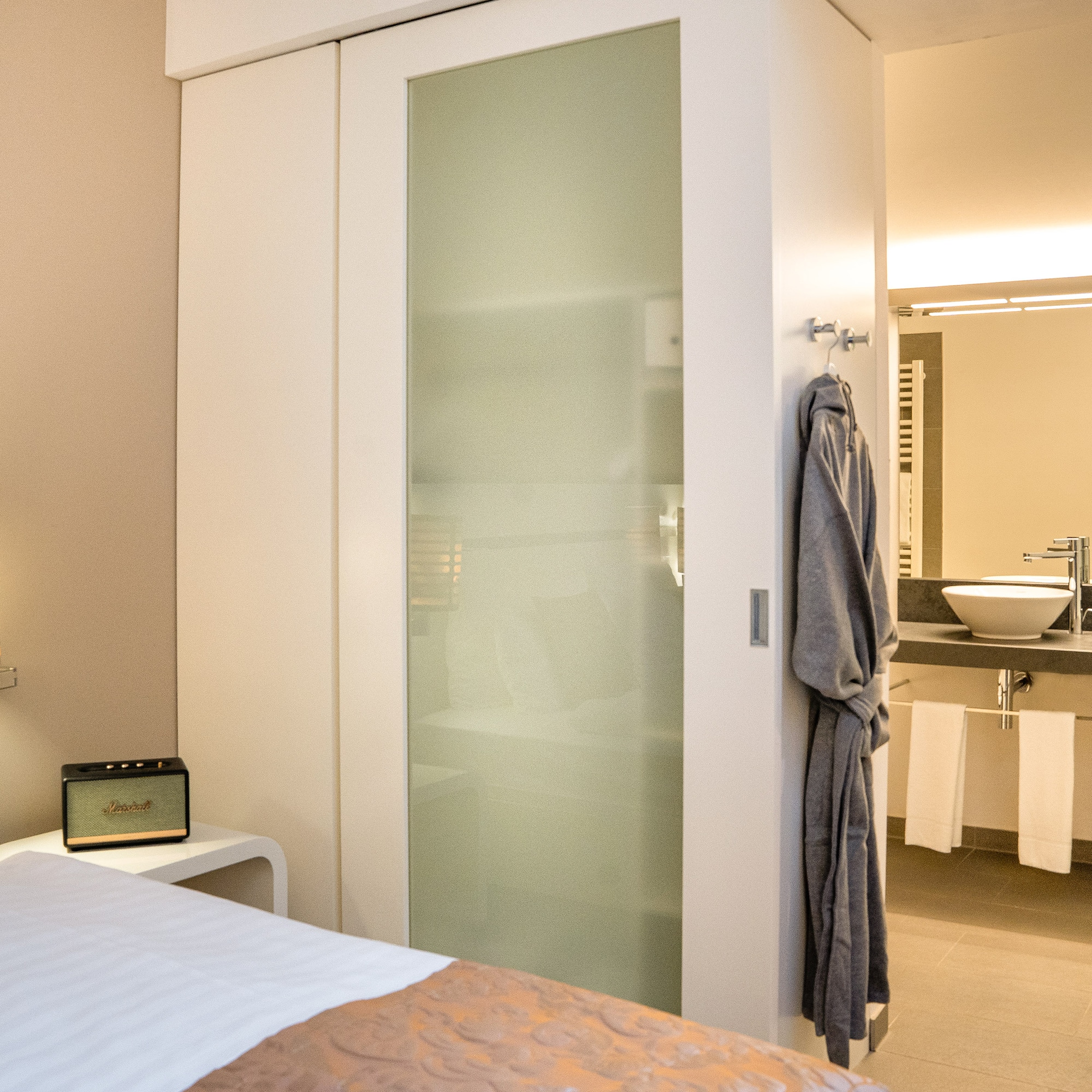 a bedroom with a door and a mirror