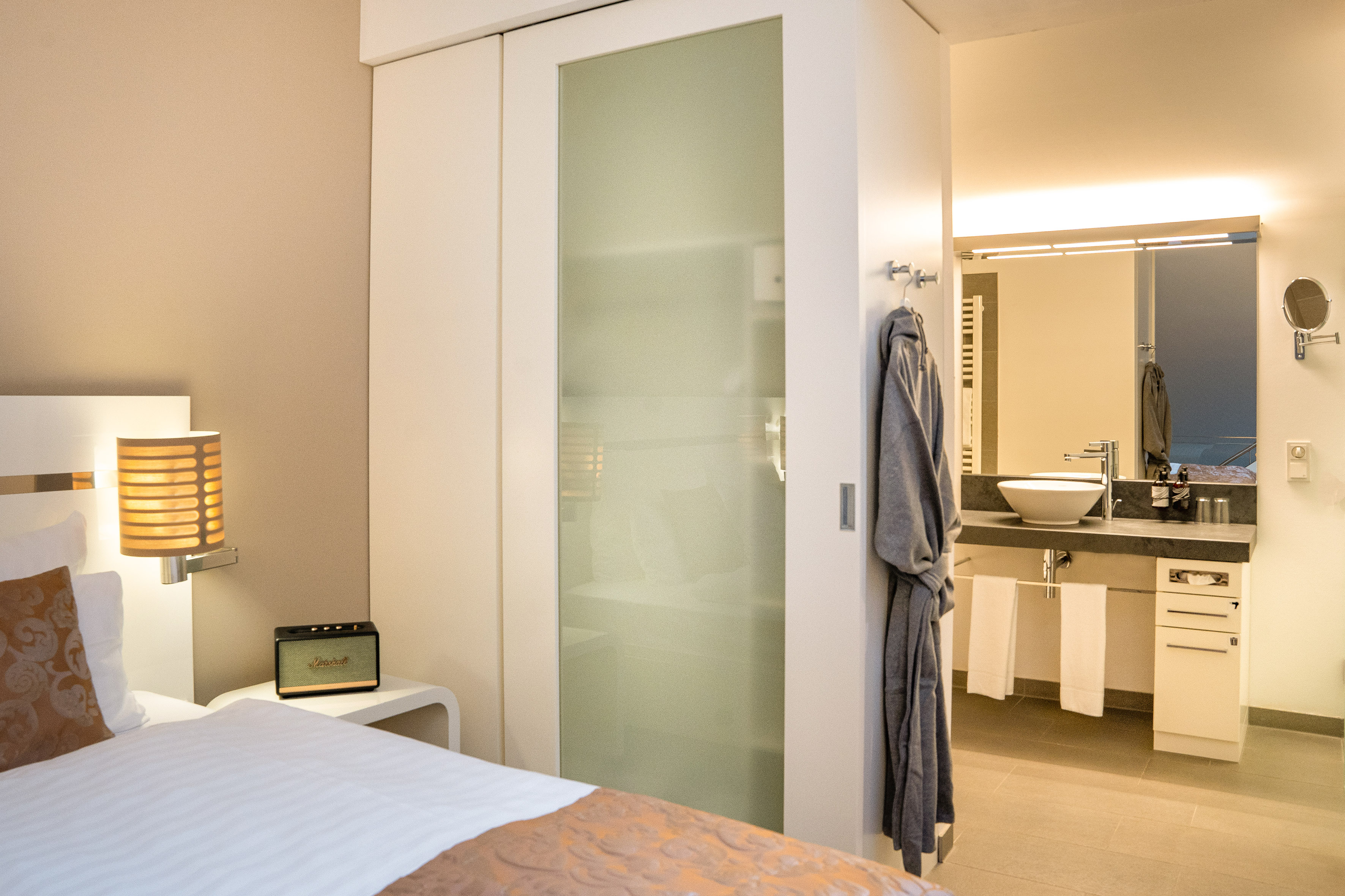 a bedroom with a door and a mirror