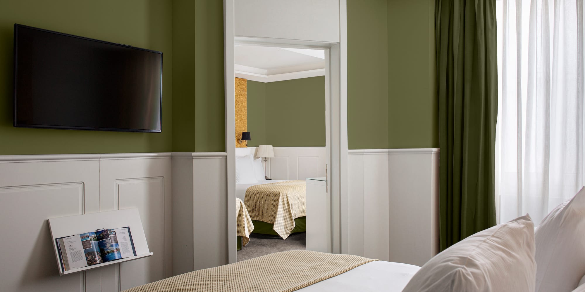 a room with a bed and a television