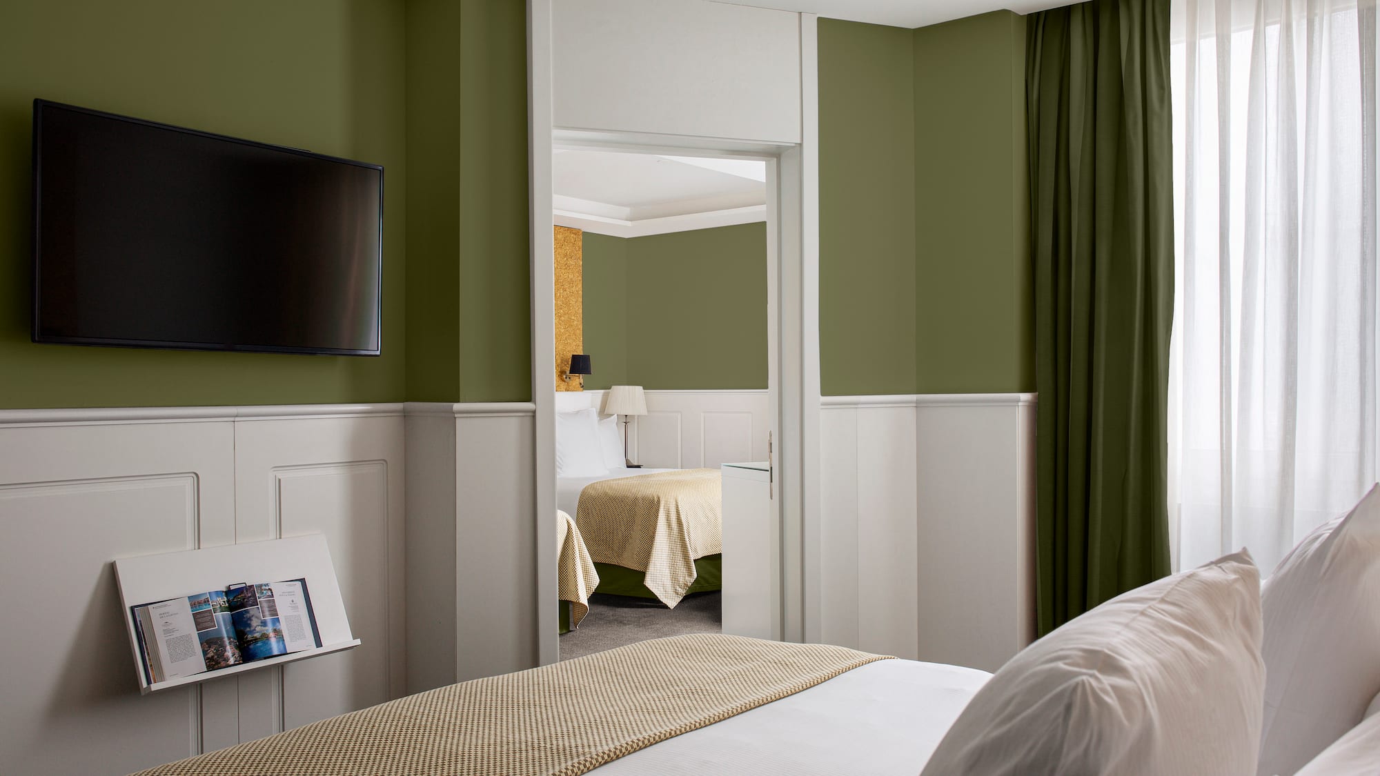 a room with a bed and a television