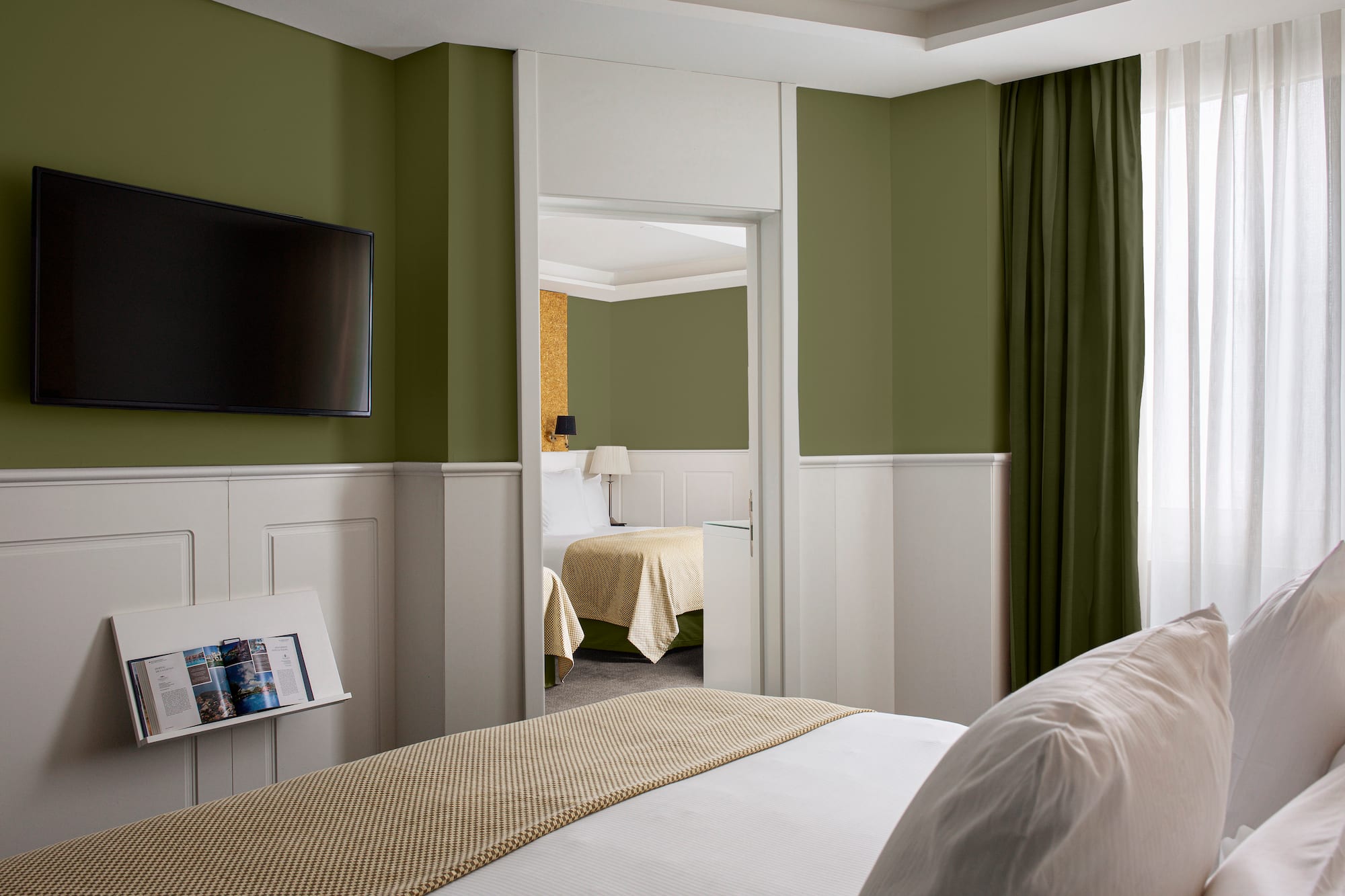 a room with a bed and a television