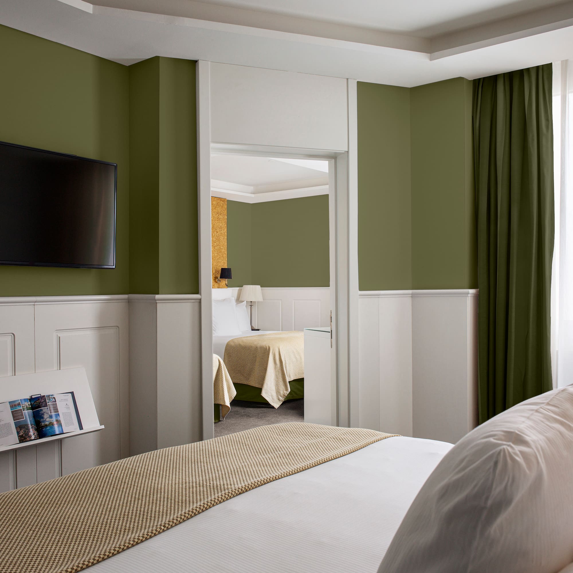 a room with a bed and a television