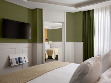 a room with a bed and a television