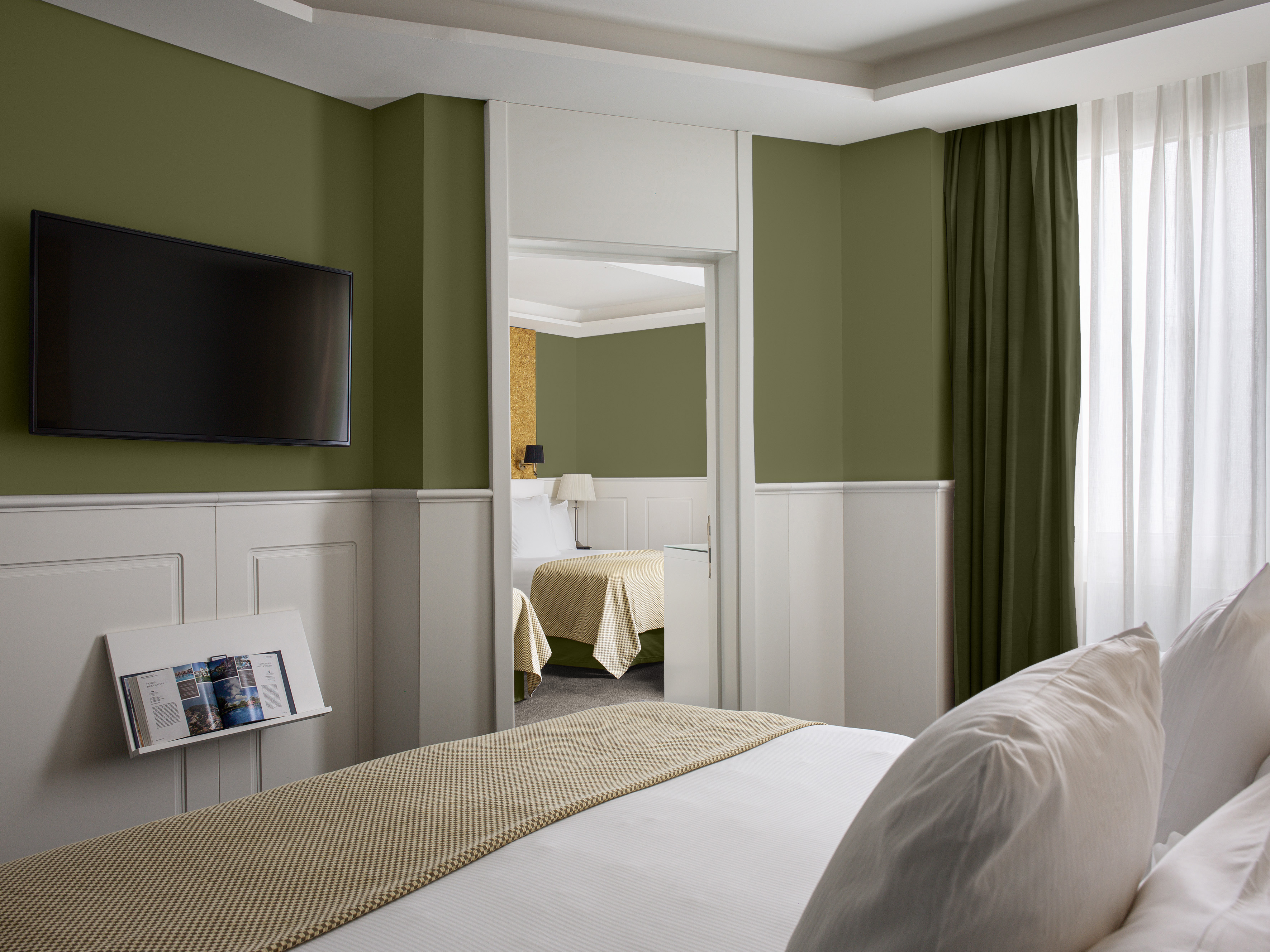 a room with a bed and a television