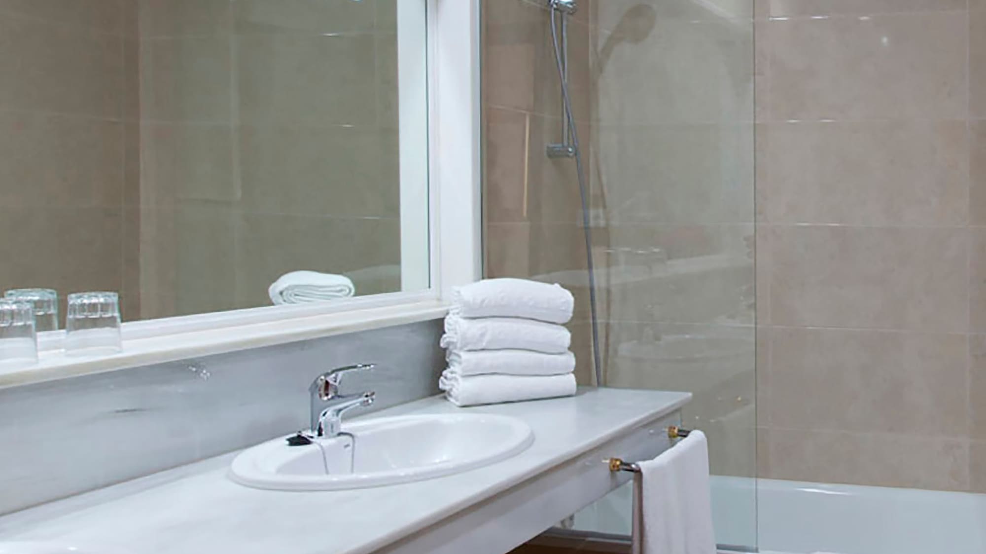 a bathroom with a shower and sink