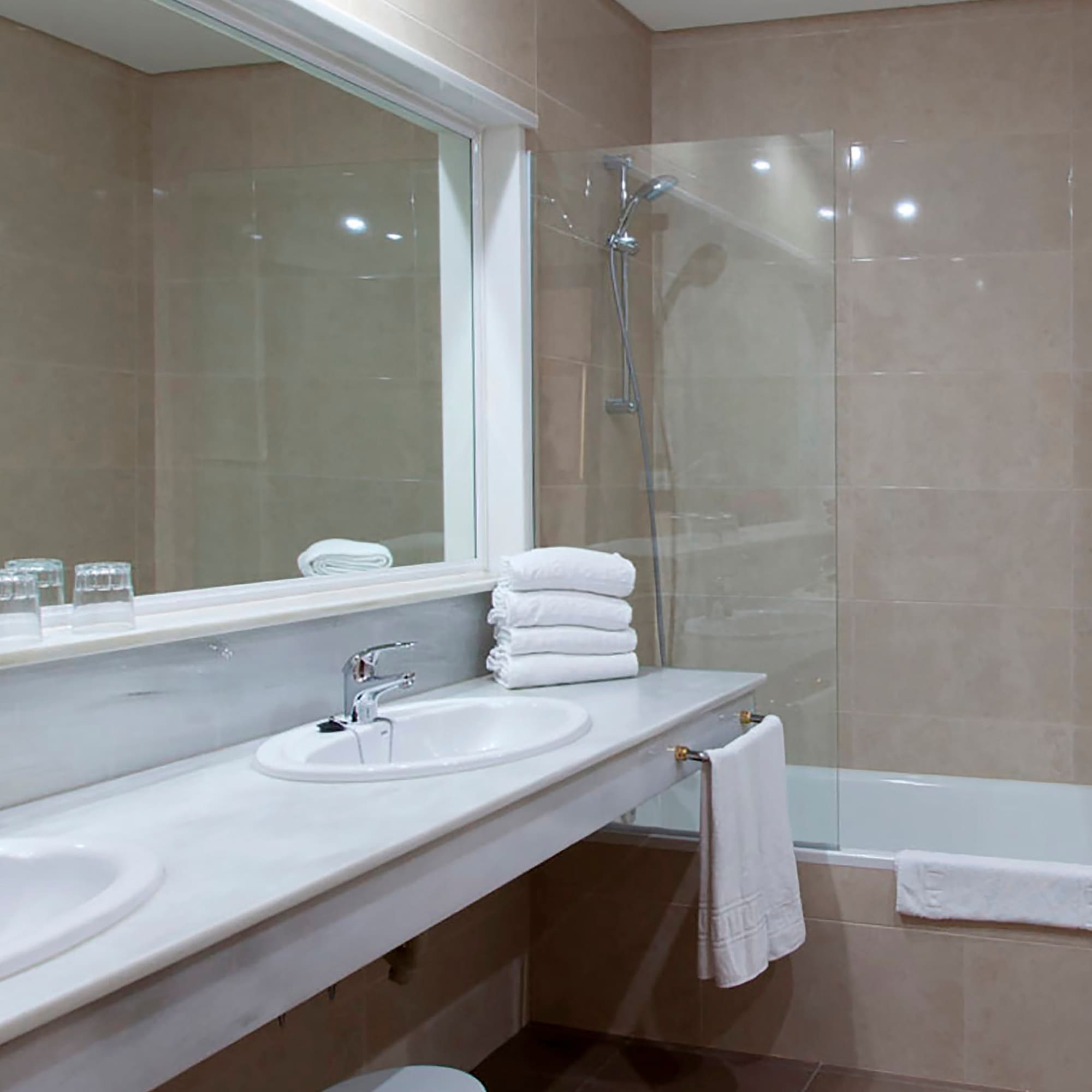 a bathroom with a shower and sink