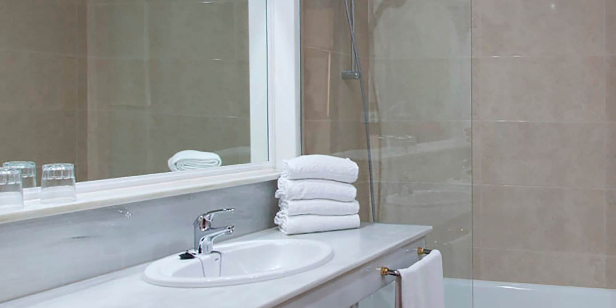 a bathroom with a shower and sink