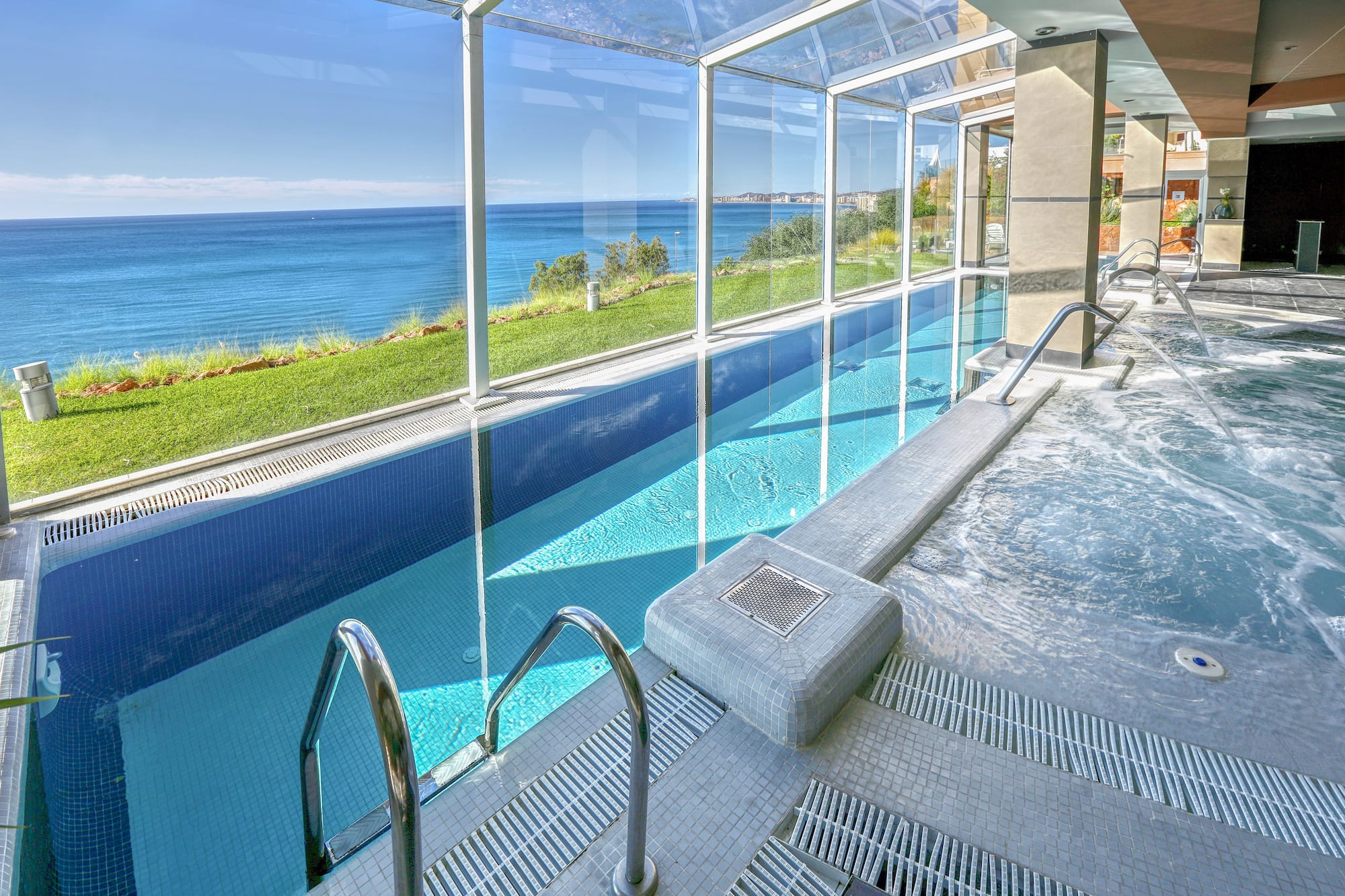 a swimming pool with a large glass wall and a large window