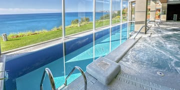a swimming pool with a large glass wall and a large window
