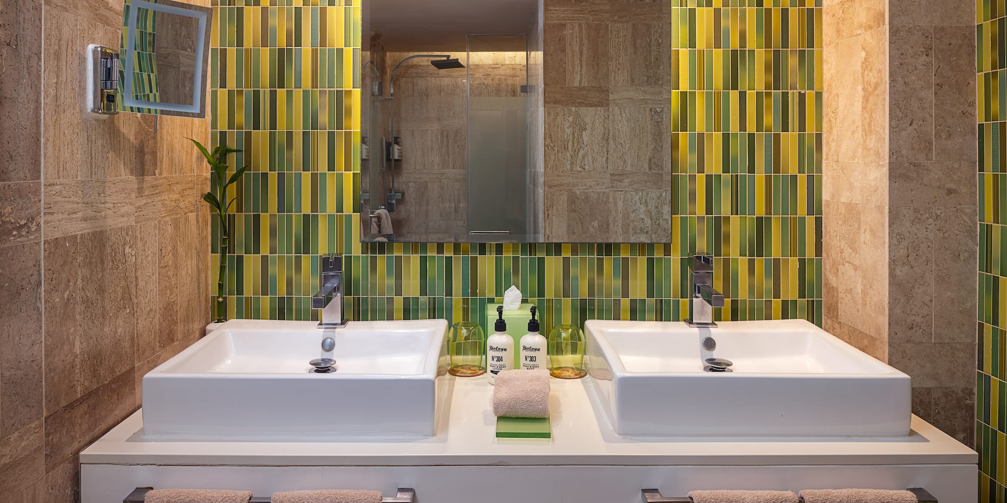 a bathroom with two sinks and a mirror