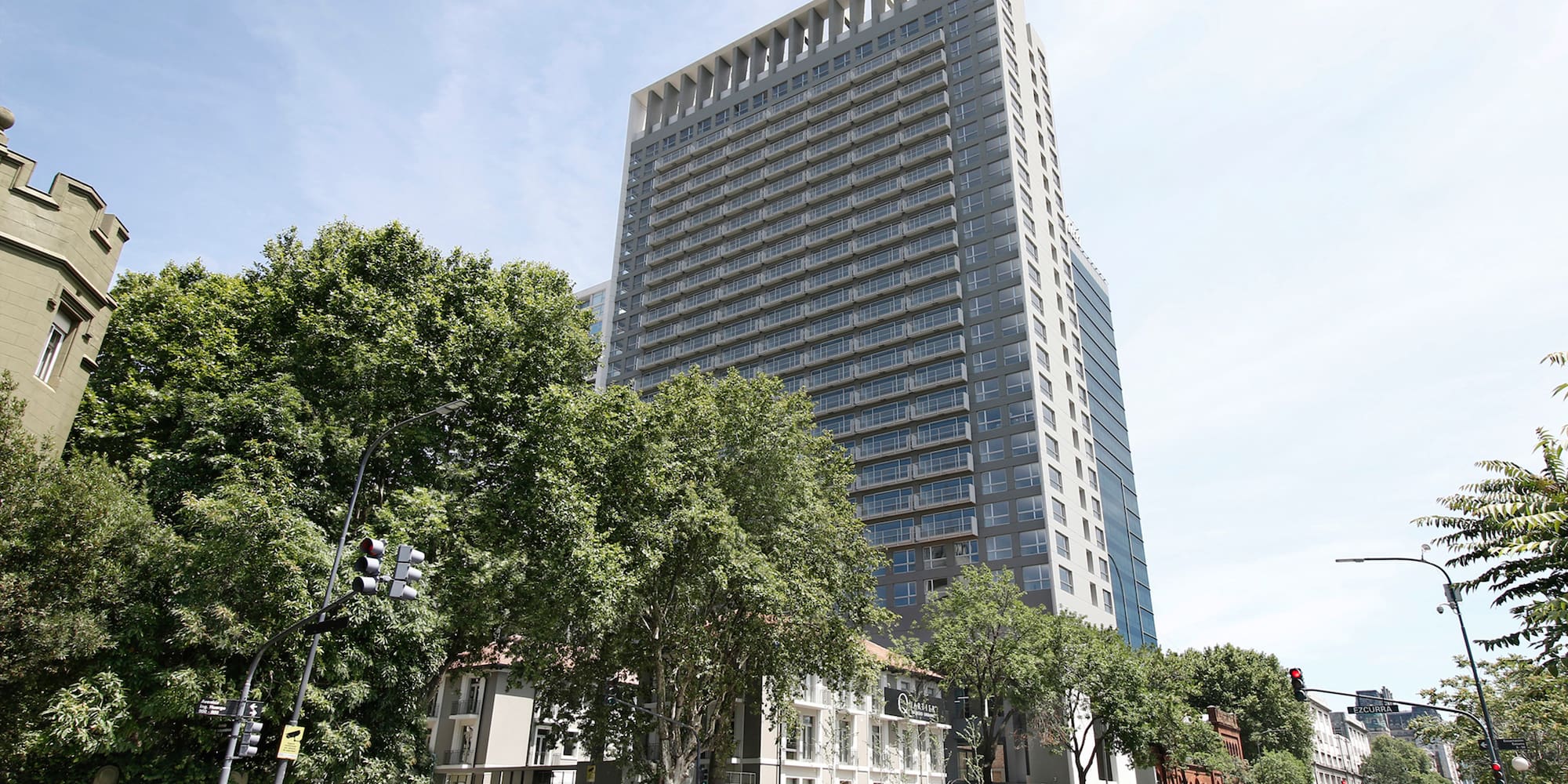 a tall building with trees in front of it
