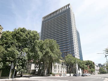 a tall building with trees in front of it