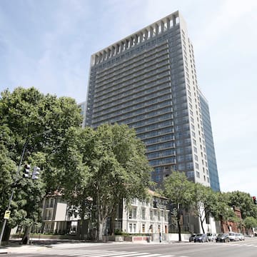 a tall building with trees in front of it