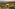 Aerial view: Tuscan villa estate, pool, vineyards, and hills at golden hour.