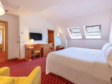 a room with a bed and a desk and a chair