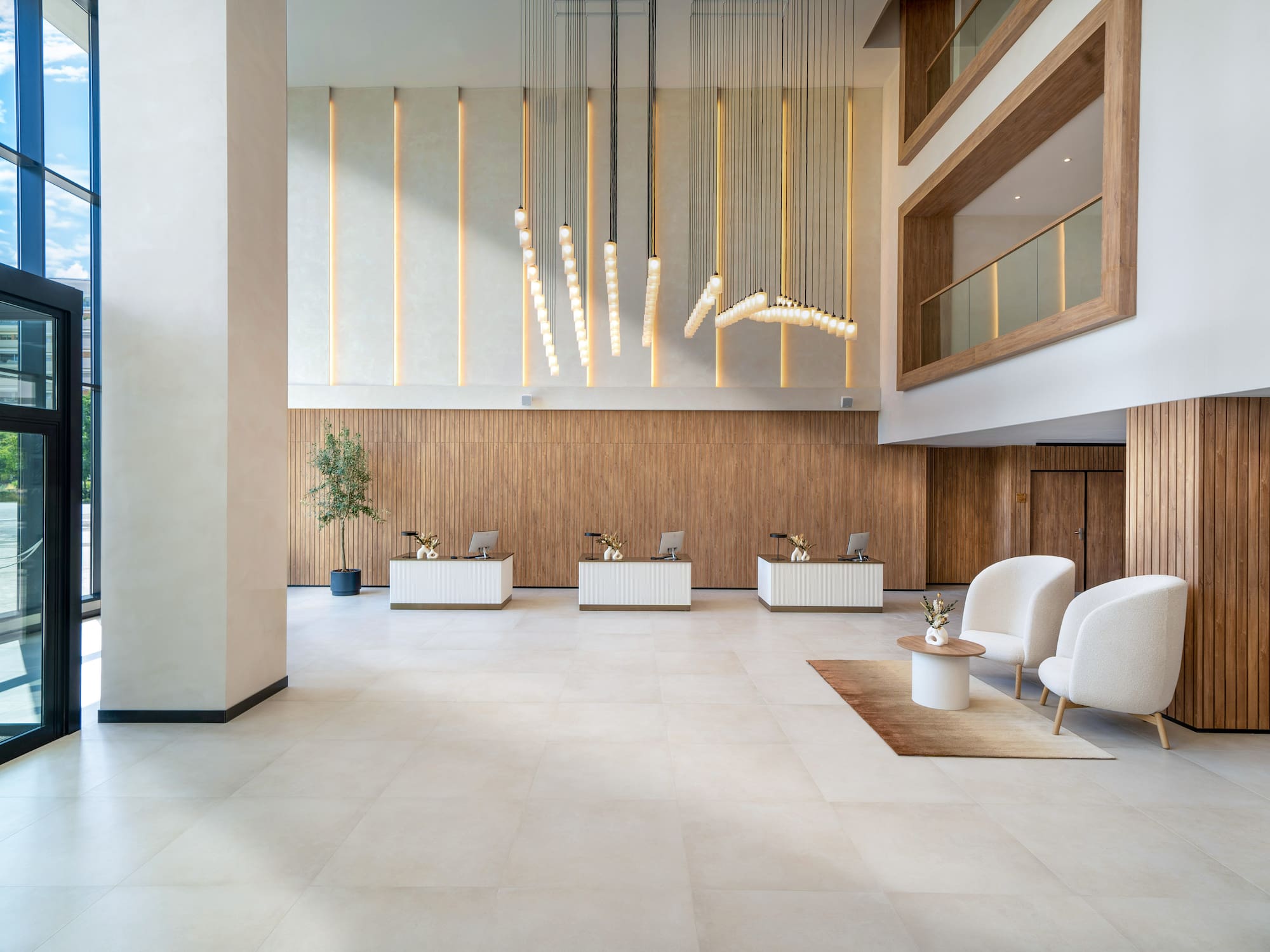 a lobby with white chairs and a table