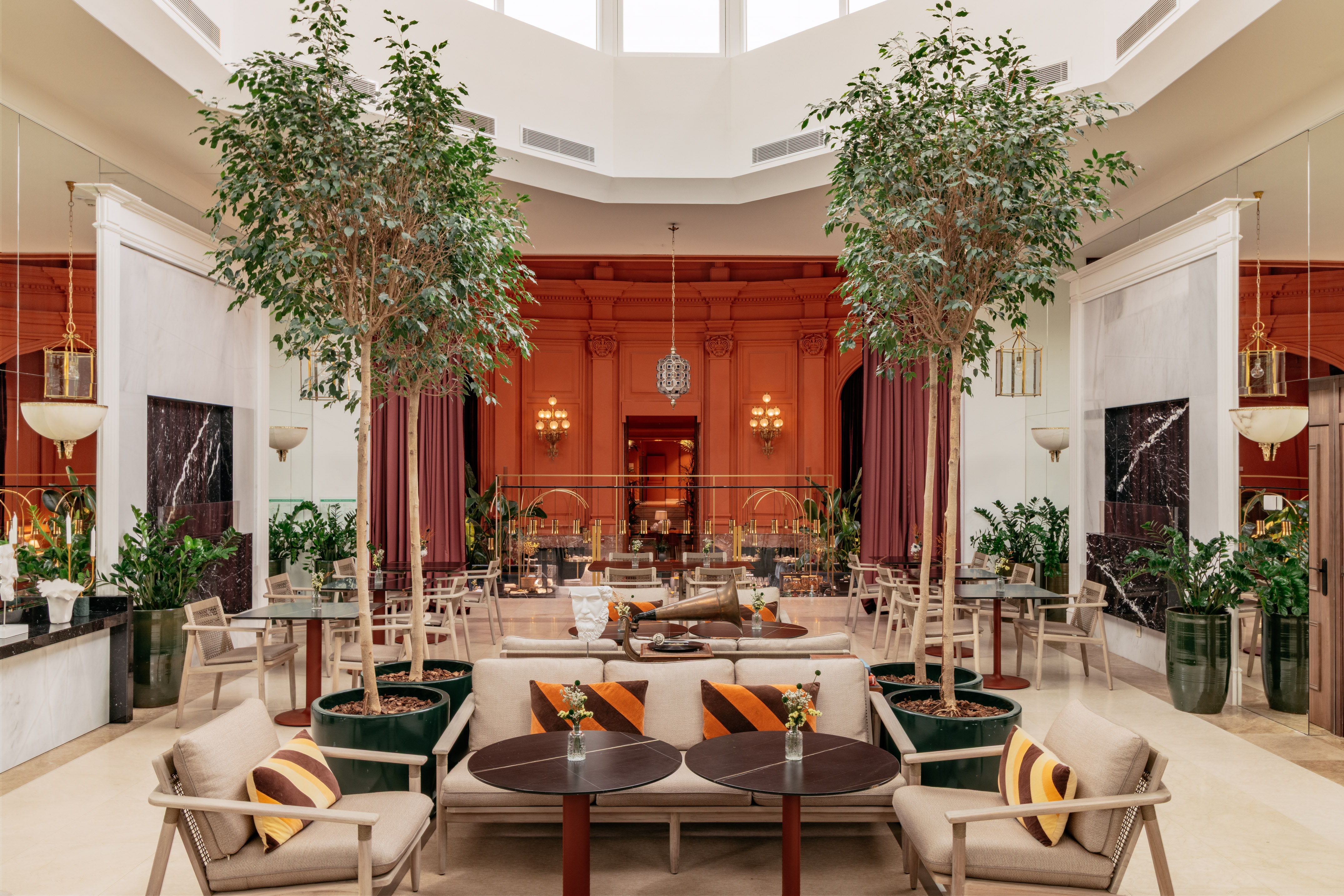 a room with tables and chairs and trees