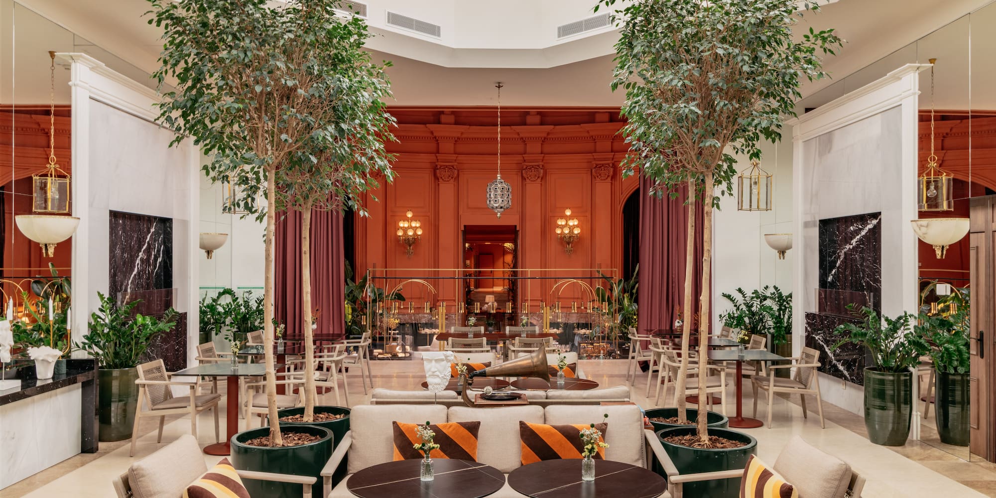 a room with tables and chairs and trees