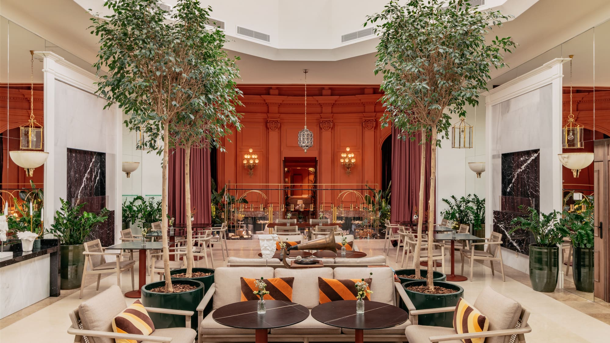 a room with tables and chairs and trees