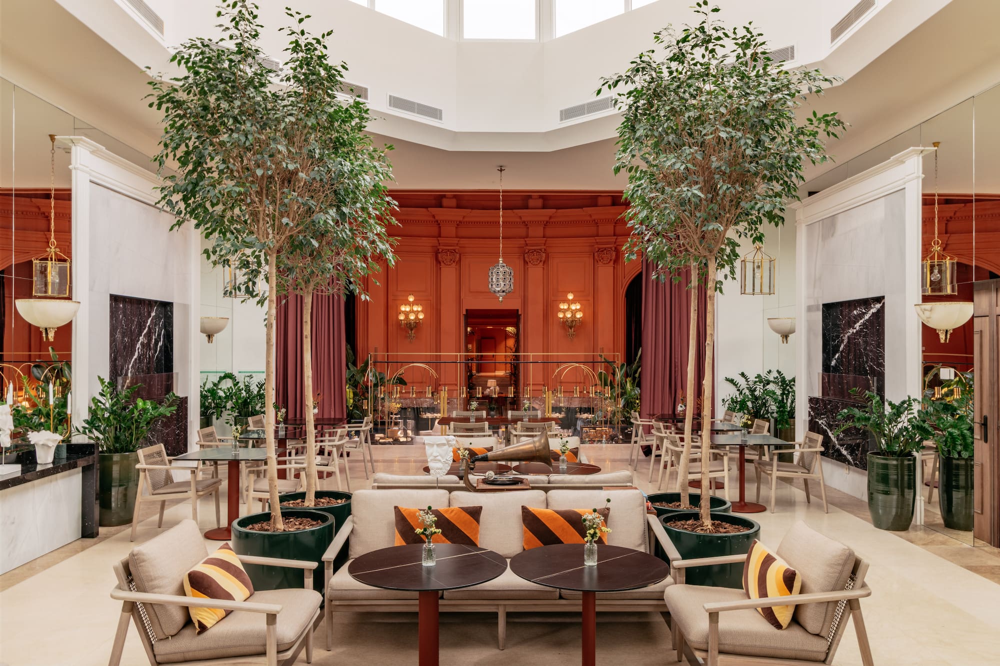 a room with tables and chairs and trees