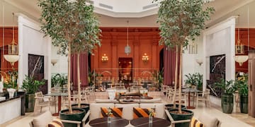 a room with tables and chairs and trees