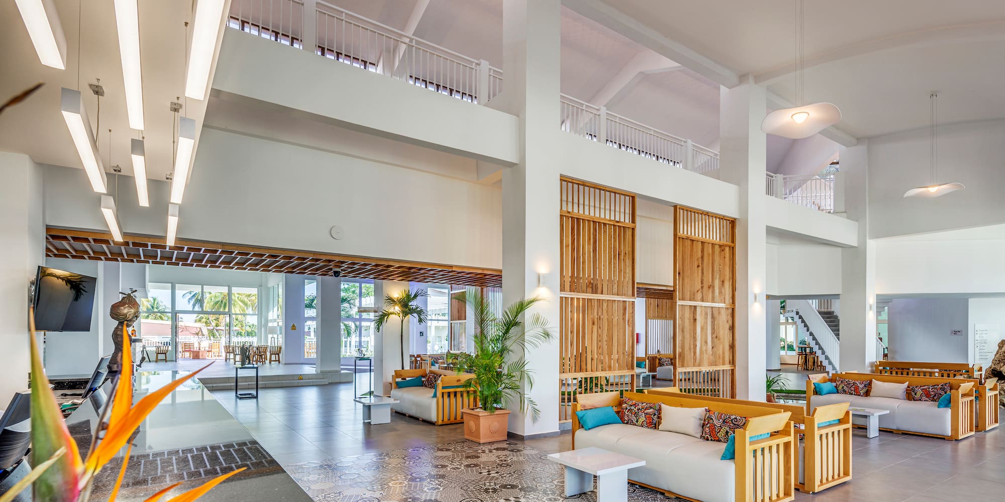 a large room with white walls and a large staircase