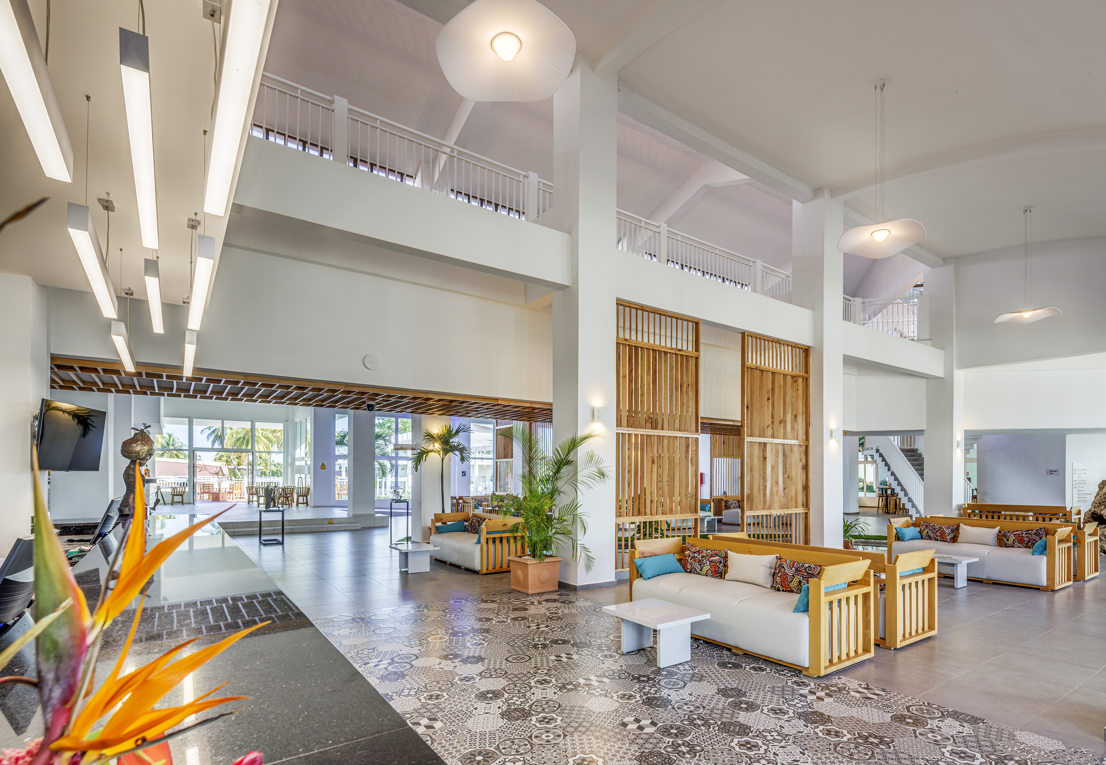 a large room with white walls and a large staircase