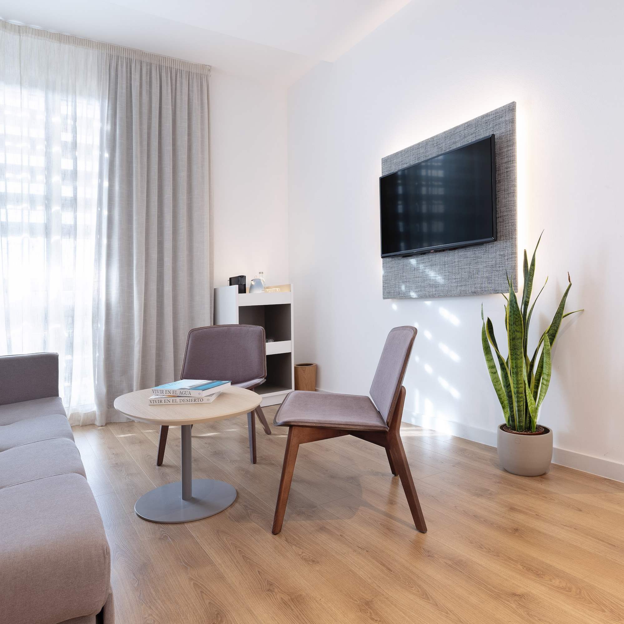 a room with a couch and a tv on the wall