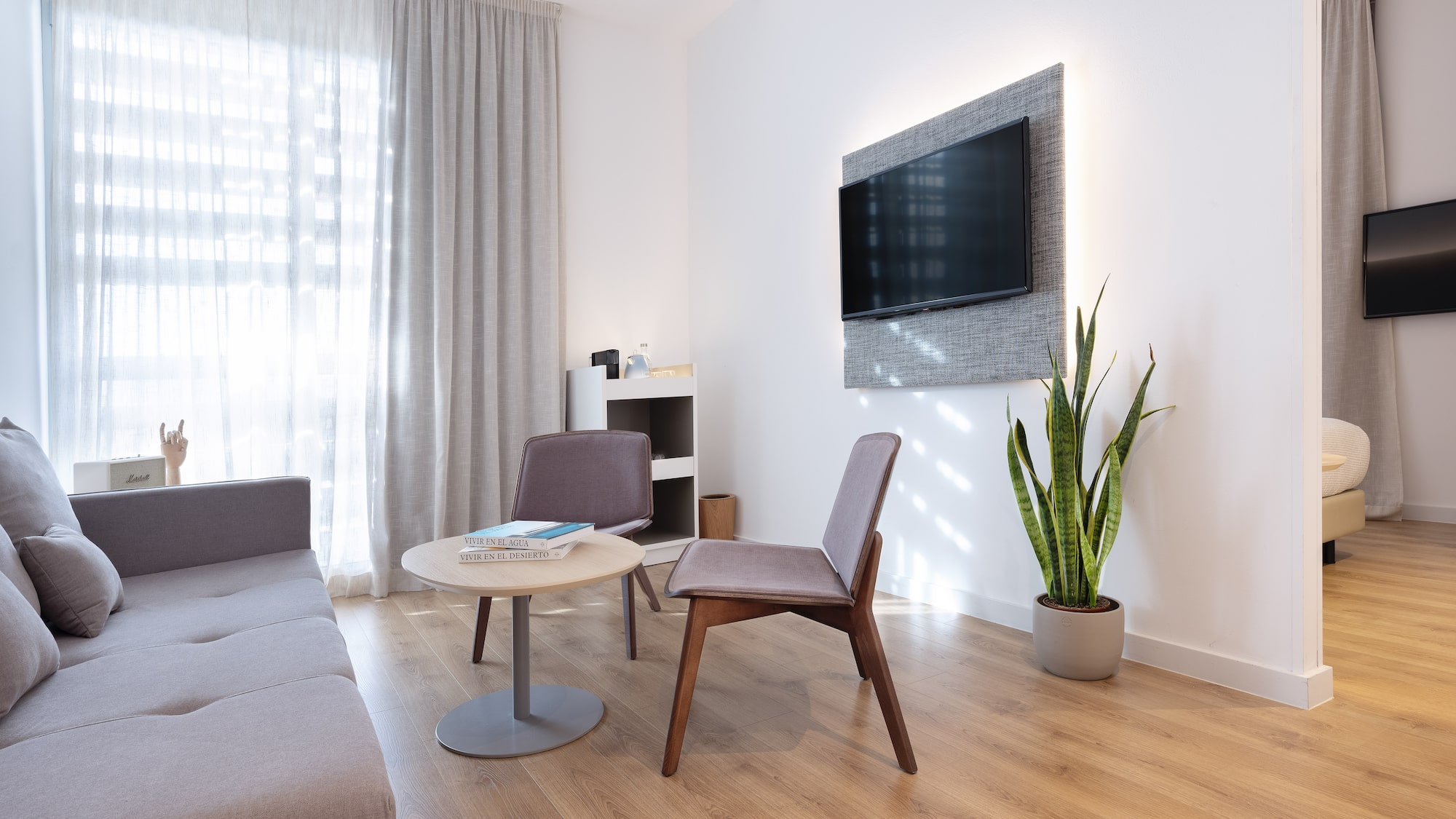 a room with a couch and a tv on the wall