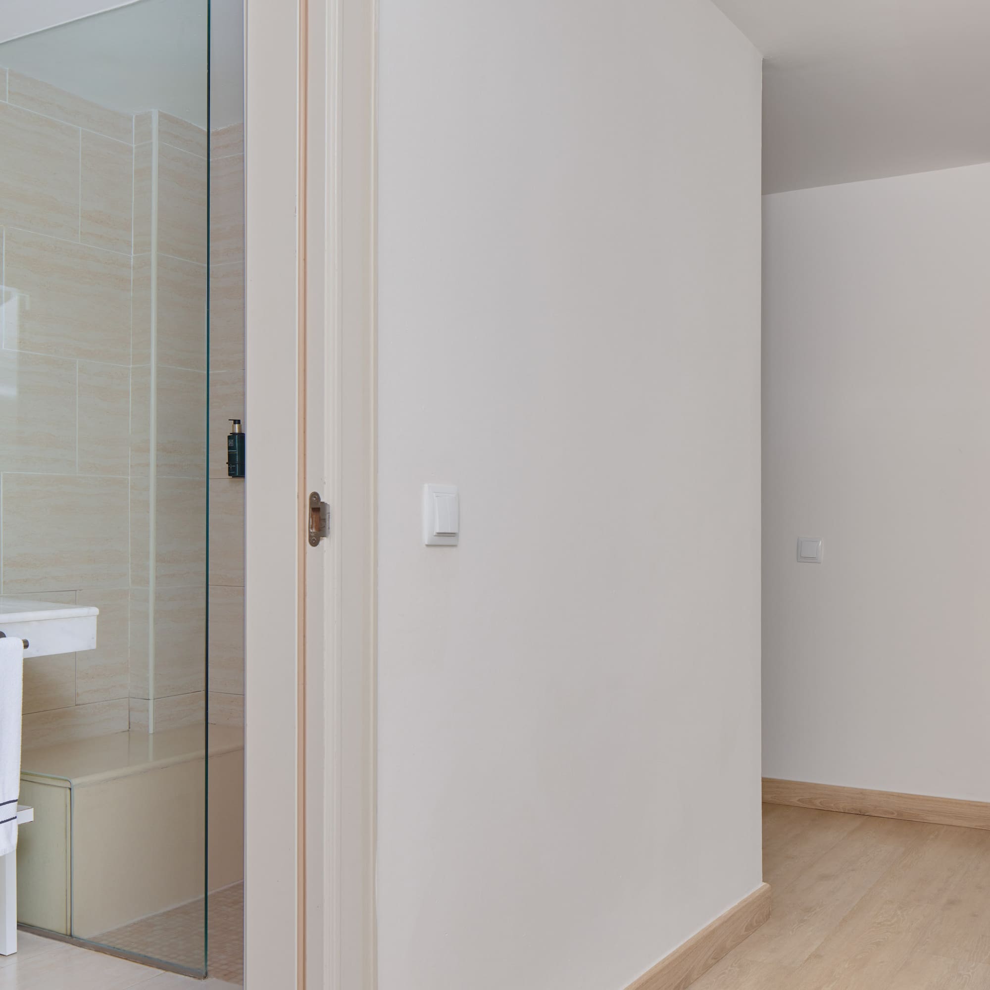 a bathroom with a glass shower door