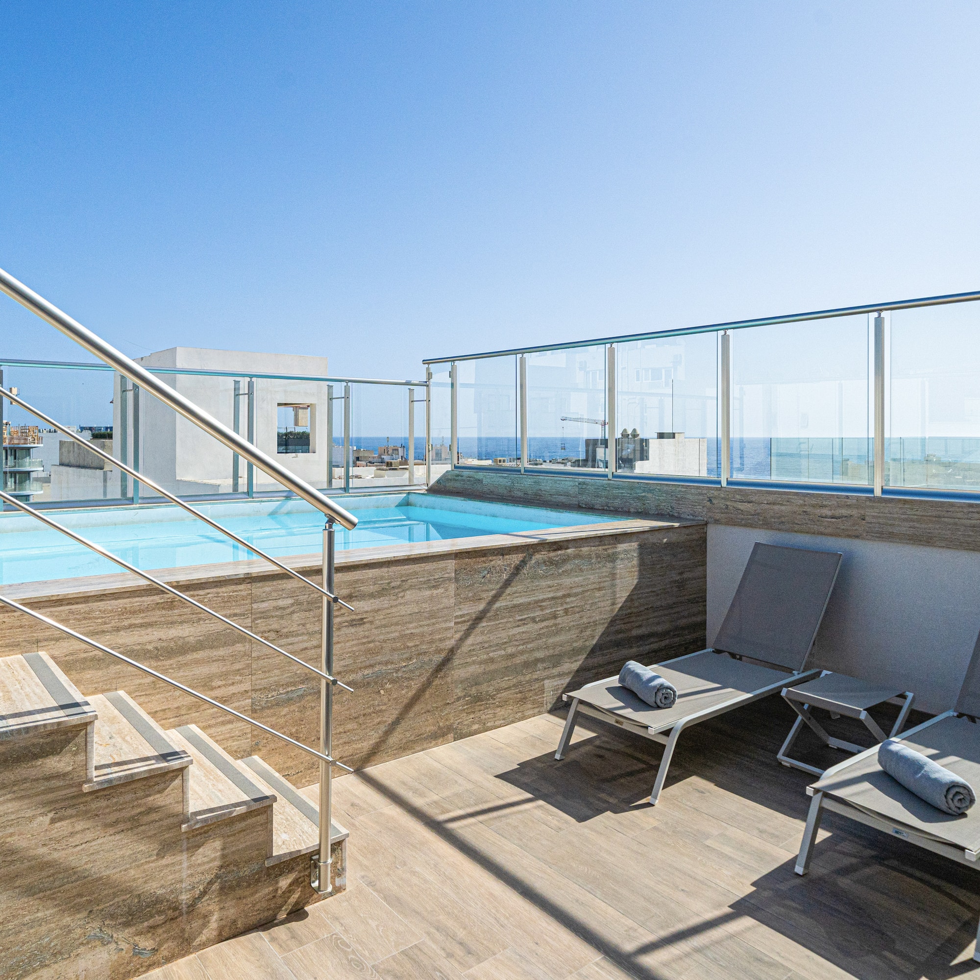 a pool with a deck chair and a railing