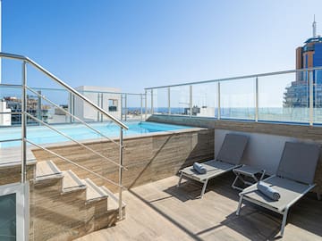 a pool with a deck chair and a railing