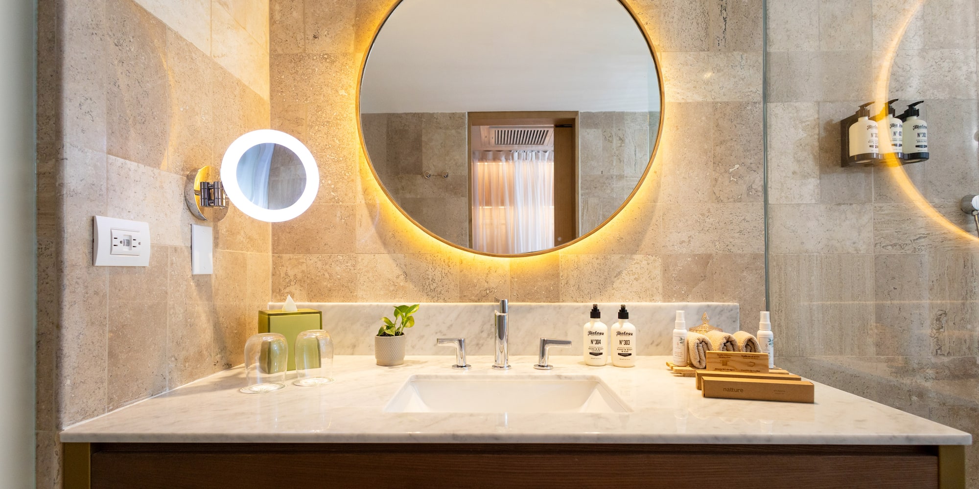 a bathroom with a round mirror