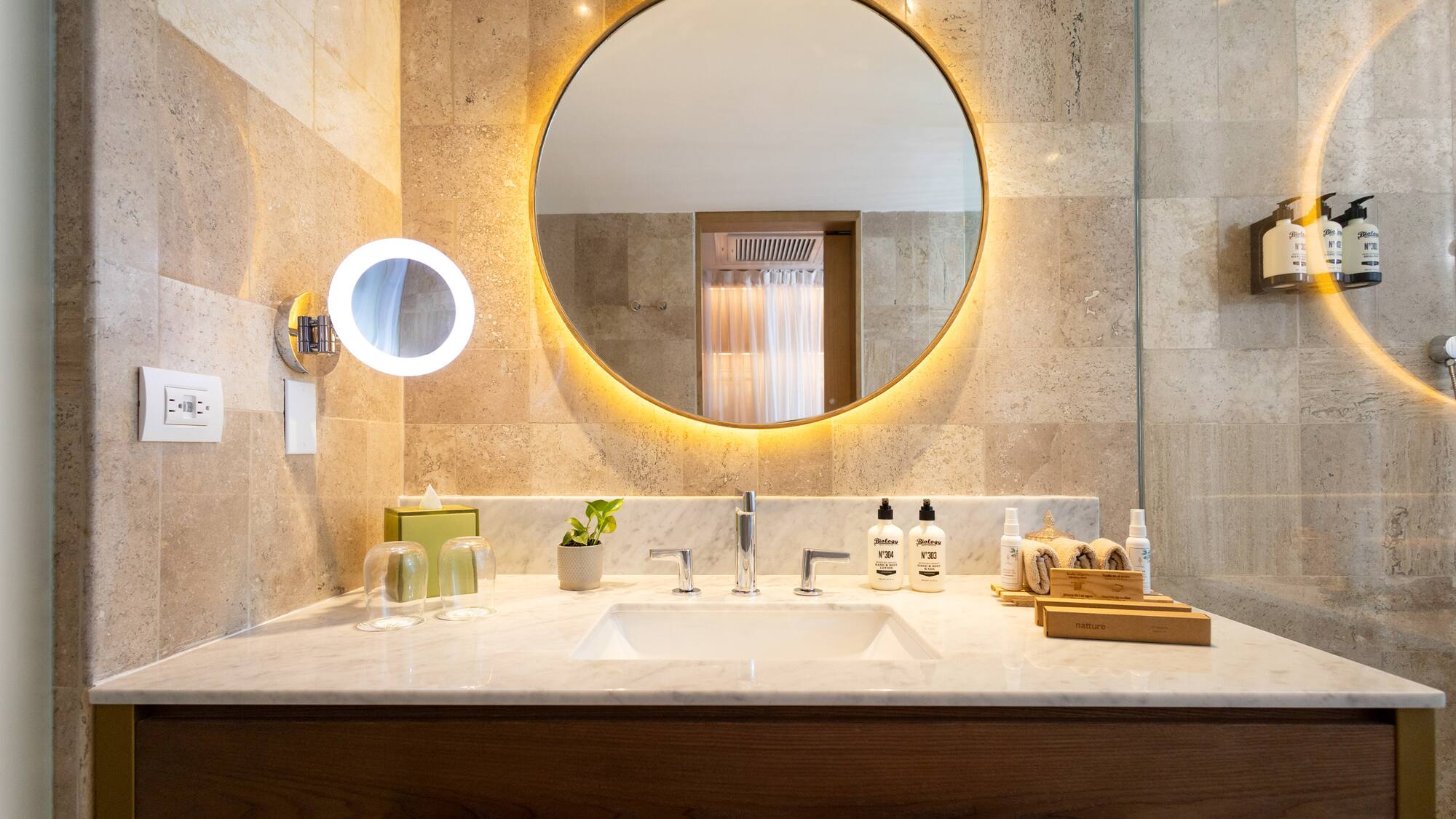 a bathroom with a round mirror
