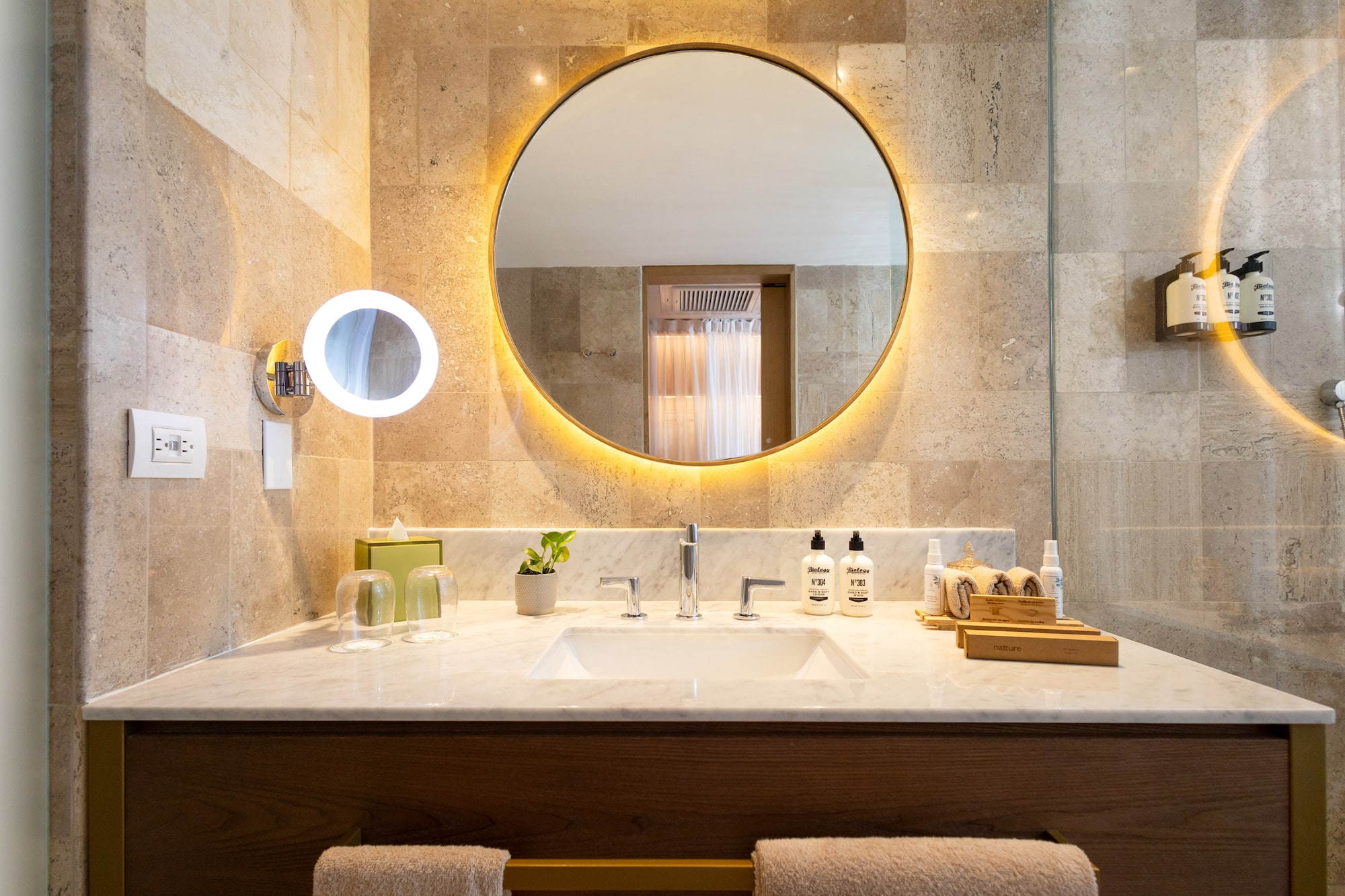 a bathroom with a round mirror